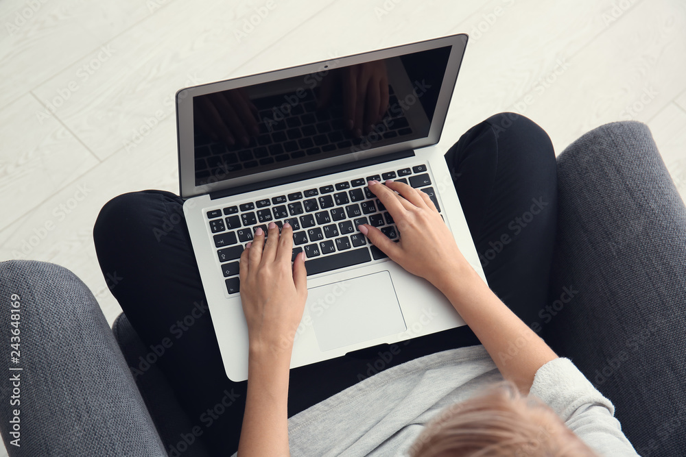 Fototapeta premium Woman working on modern laptop at home