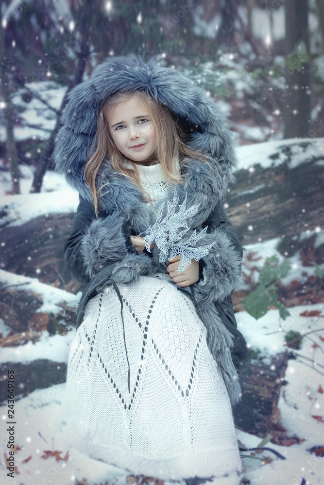 Portrait of a little girl in a fur coat. Portrait of a little girl in a fur coat.