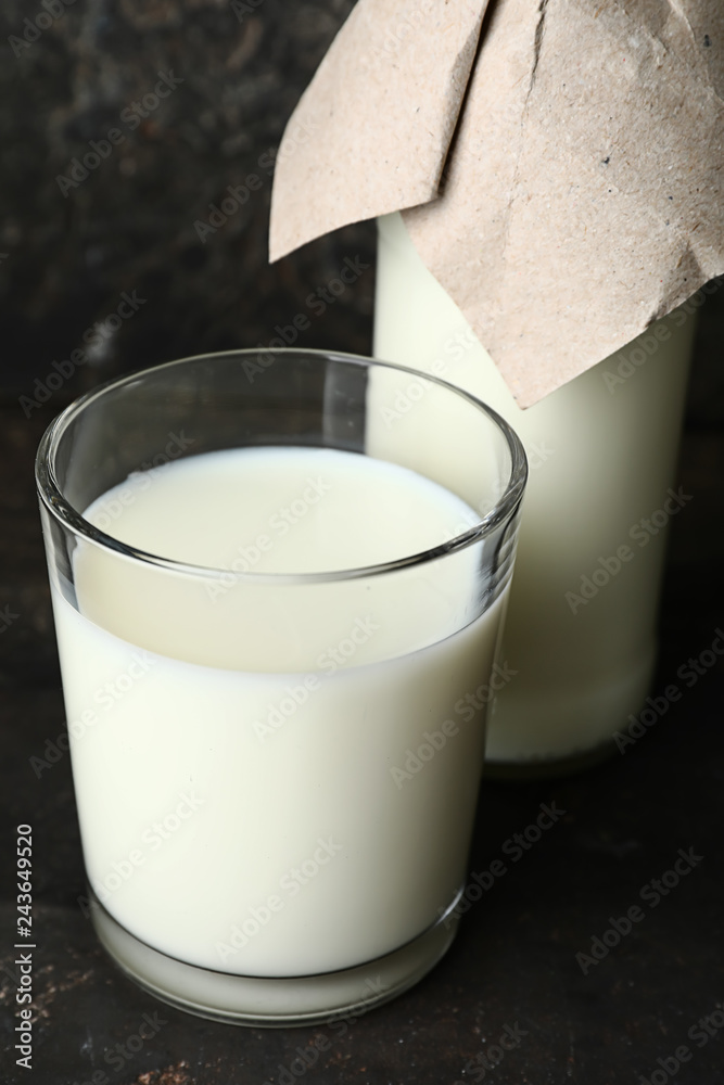 Glass and bottle of milk on table Glass and bottle of milk on table