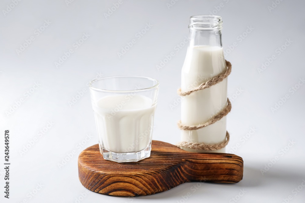 Glass and bottle of fresh milk on white background Glass and bottle of fresh milk on white background