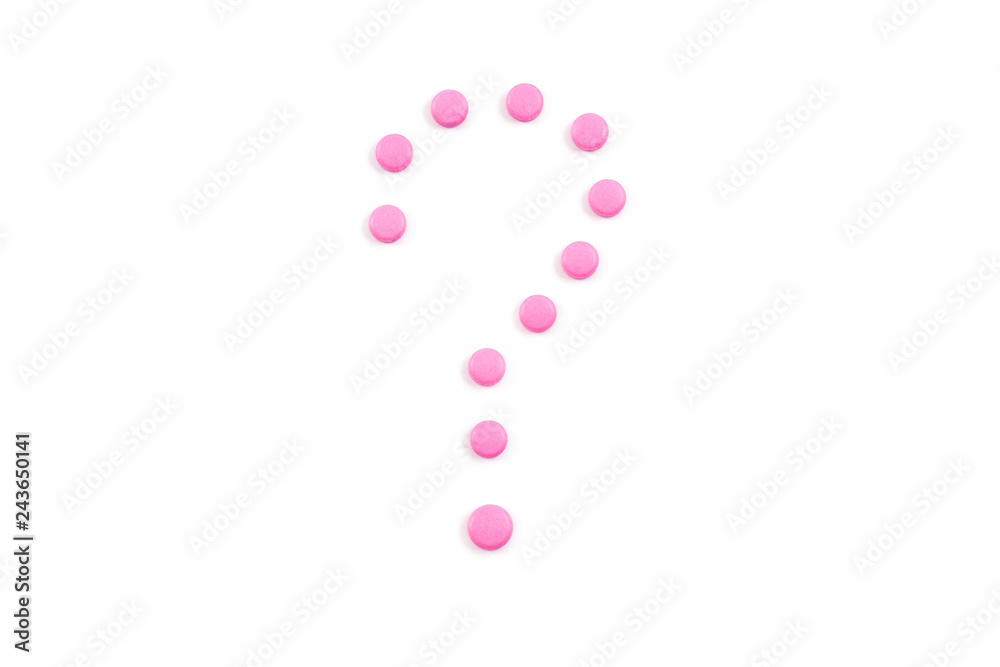 Symbol question mark made from pink pills or tablets on white background.