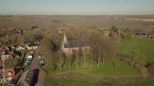 Aerial drone shot from the Andreas Church located on a mound in the center of Westeremden, The Netherlands. photo