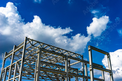New home under construction using steel frames against a sunny sky
