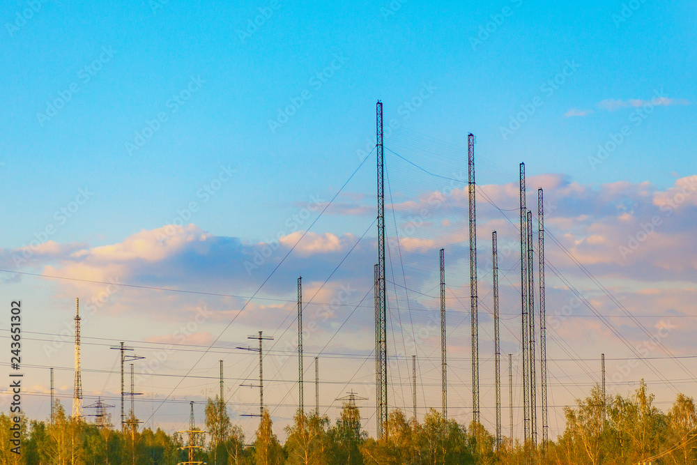 industrial landscape with antennas for broadcasting radio and television at sunset