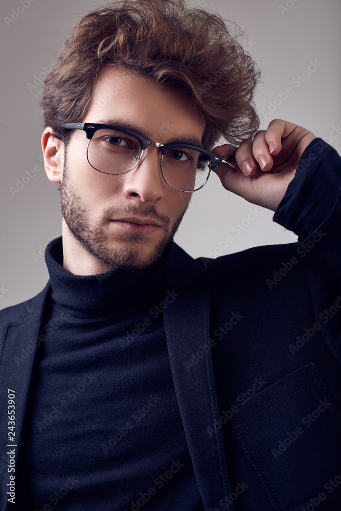 Handsome elegant man with curly hair wearing suit and glasses Handsome elegant man with curly hair wearing suit and glasses