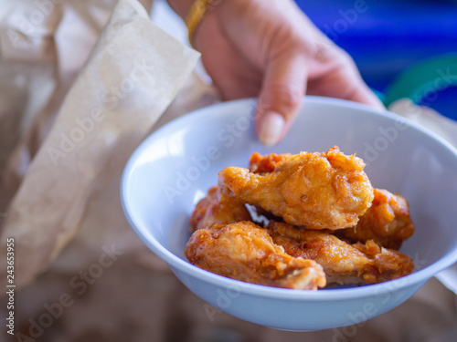 Close up of fried chicken leg in a blue dish