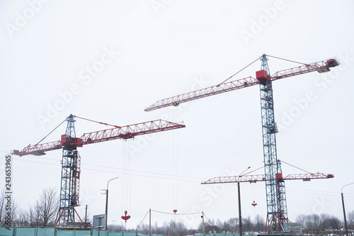Red construction tower crane. Two cranes construction