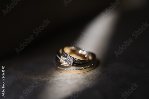 Gold wedding rings with diamonds of the bride and groom, close-up