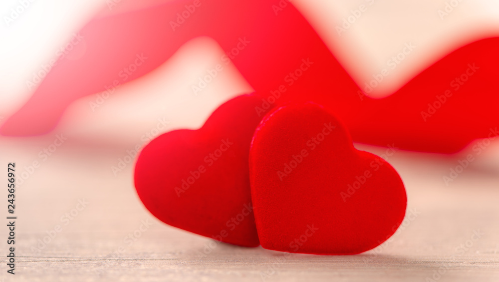 Fototapeta premium Concept of Valentine, anniversary, wedding celebration, heart shapes on a white wooden bench, bokeh background, close up