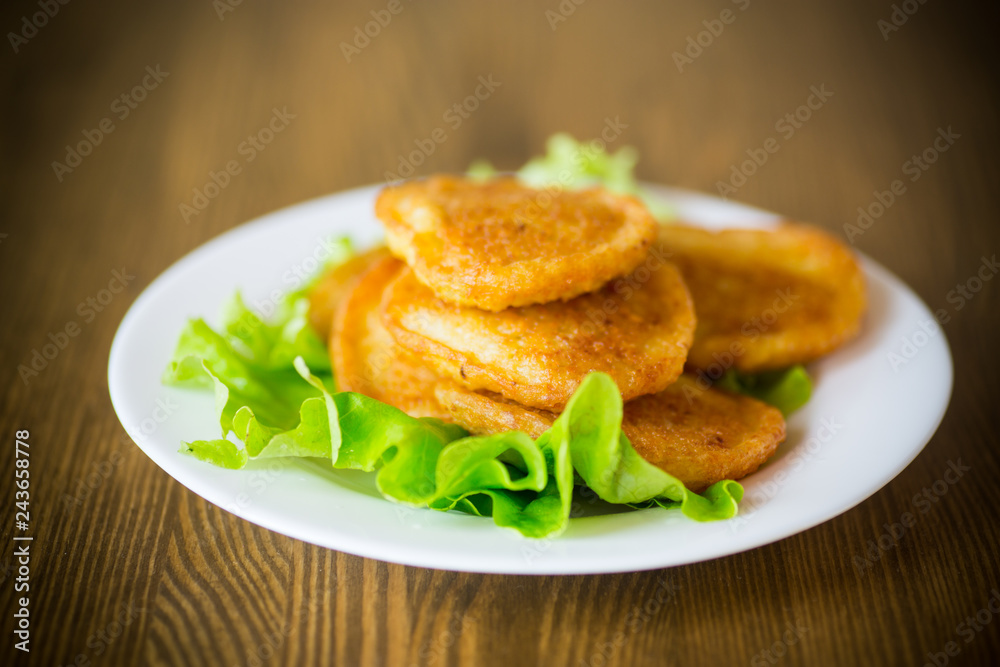 potato pancakes with lettuce leaves in a plate potato pancakes with lettuce leaves in a plate