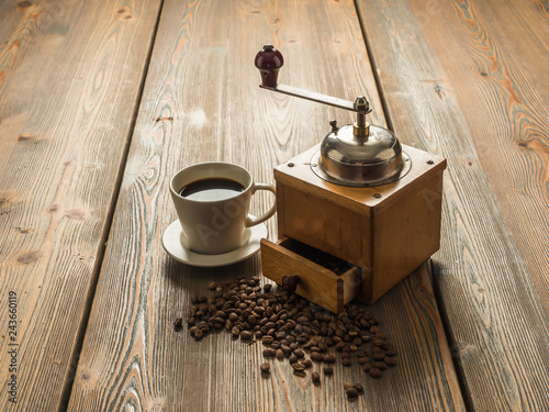 Black coffee, coffee beans and grinder