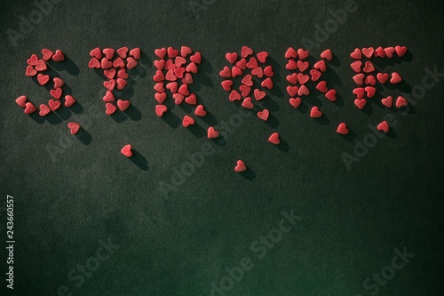 Inscription Stroke from small hearts. photo