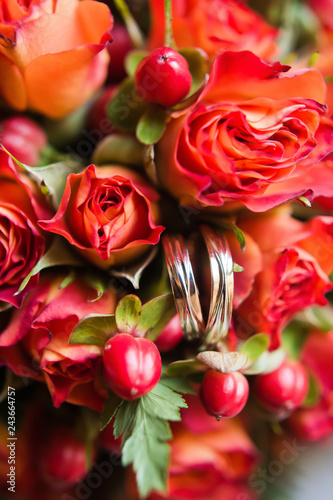 Two wedding rings. The background of red roses