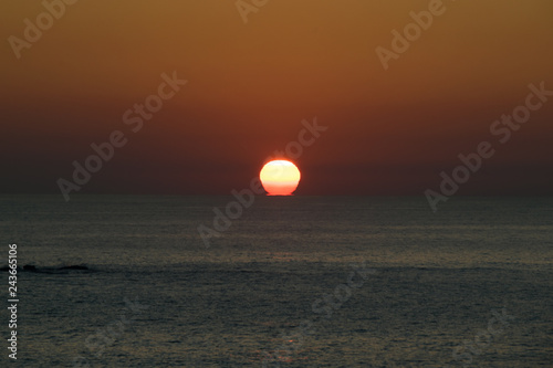 Fototapeta Naklejka Na Ścianę i Meble -  sunset over the sea. Sun hiding under the water