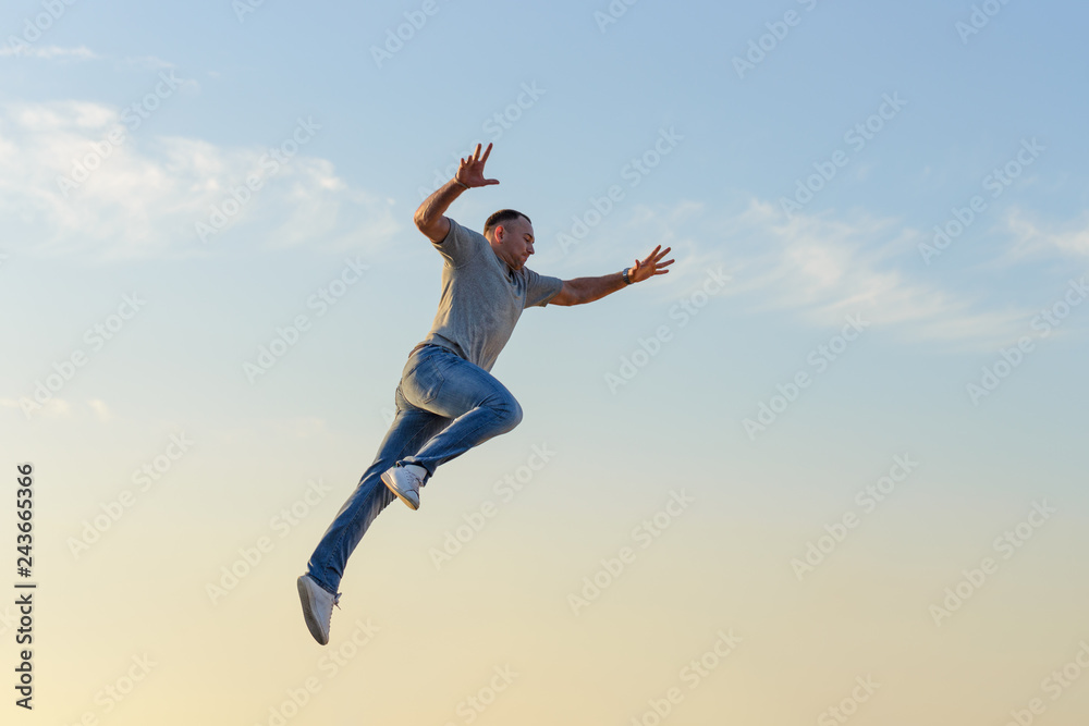 young man in a jump against a blue sky