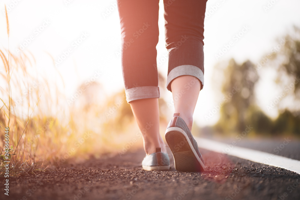 Closeup woman walking towards on the road side. Step concept. Closeup woman walking towards on the road side. Step concept.