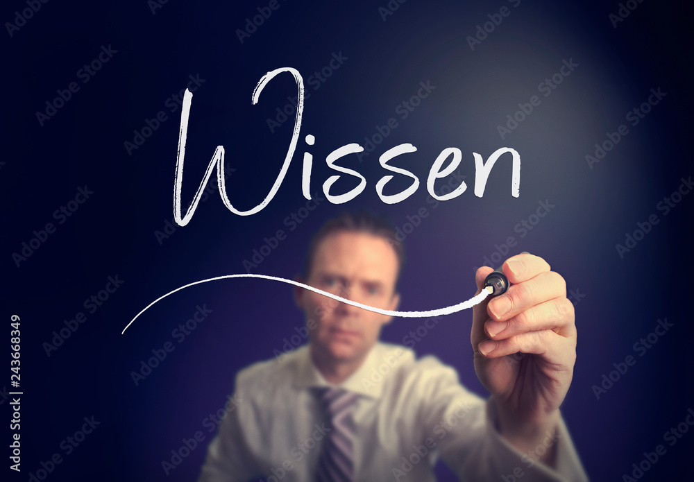 A businessman writing a Knowledge A businessman writing a Knowledge