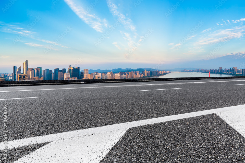 Empty asphalt road and city skyline at sunrise in hangzhou,high angle view