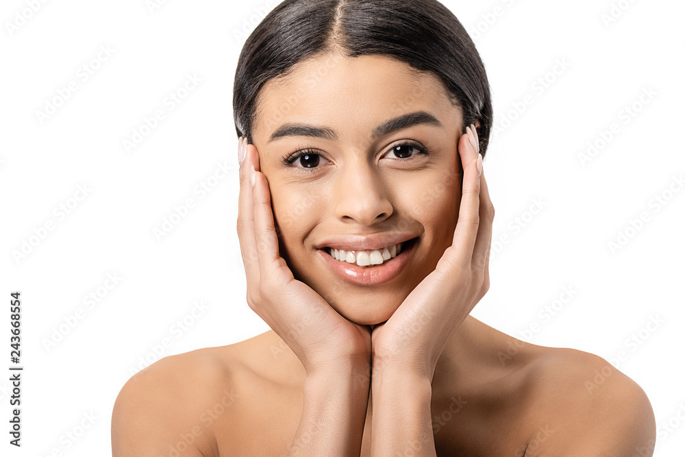 attractive happy african american girl touching face and smiling at camera isolated on white attractive happy african american girl touching face and smiling at camera isolated on white