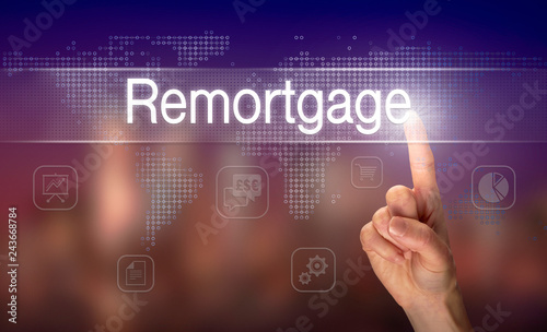 A hand selecting a Remortgage business concept on a clear screen with a colorful blurred background. photo