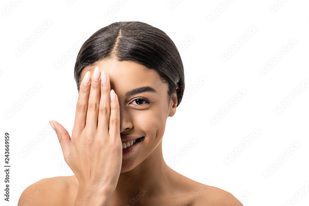 beautiful young african american woman closing eye with hand and smiling at camera isolated on white beautiful young african american woman closing eye with hand and smiling at camera isolated on white