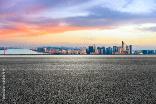 Empty asphalt road and city skyline at sunrise in hangzhou