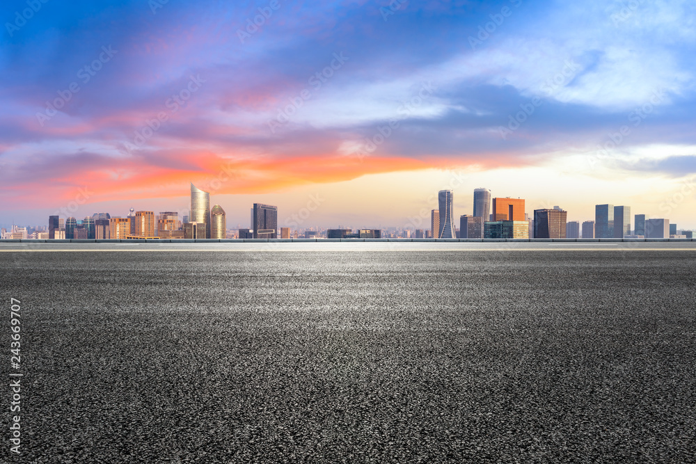 Empty asphalt road and city skyline at sunrise in hangzhou