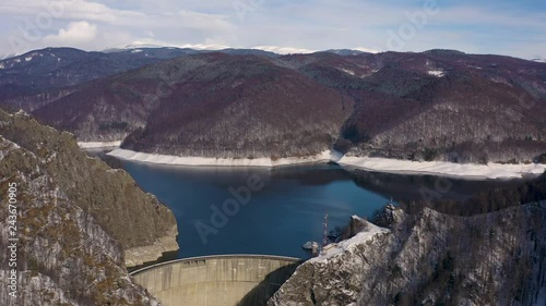  4K aerial footage with dam lake Vidraru in Romania during winter