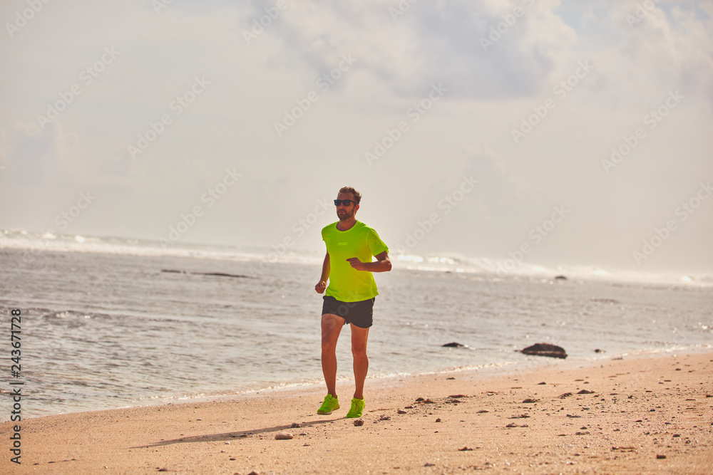 Man running / jogging on a tropical exotic beach. Man running / jogging on a tropical exotic beach.