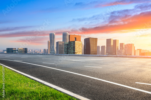 Empty asphalt road and city skyline in Hangzhou at sunrise high angle view