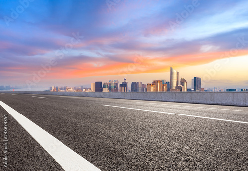 Empty asphalt road and city skyline in Hangzhou at sunrise,high angle view