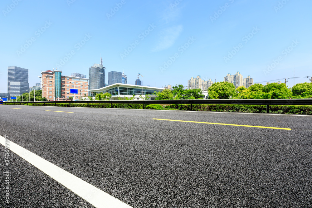 Asphalt road and modern city commercial building in Shanghai