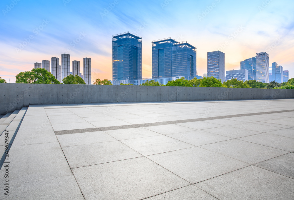 Empty square floor and city skyline with buildings in Shanghai at dusk Empty square floor and city skyline with buildings in Shanghai at dusk