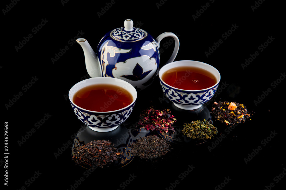 tea on a black background with reflection tea on a black background with reflection