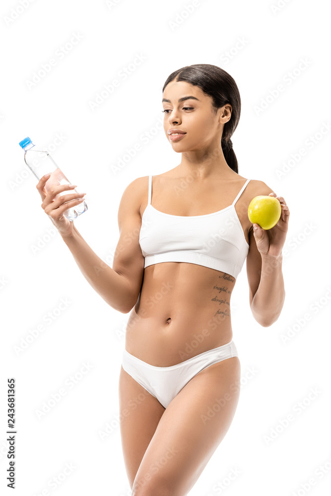 slim young african american woman in underwear holding bottle of water and green apple isolated on white slim young african american woman in underwear holding bottle of water and green apple isolated on white