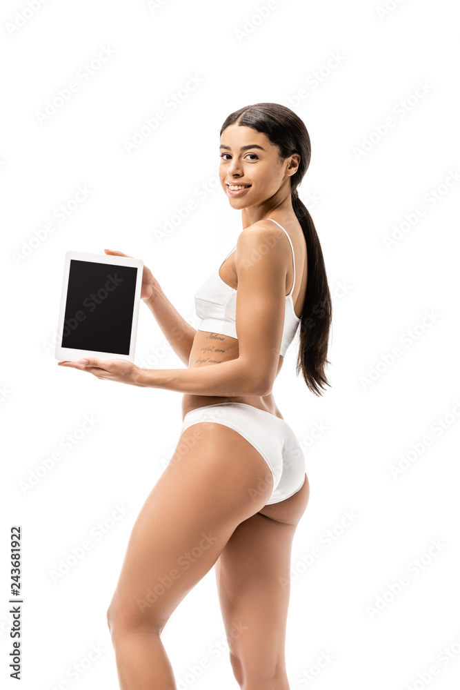 young african american woman in white underwear holding digital tablet and smiling at camera isolated on white young african american woman in white underwear holding digital tablet and smiling at camera isolated on white