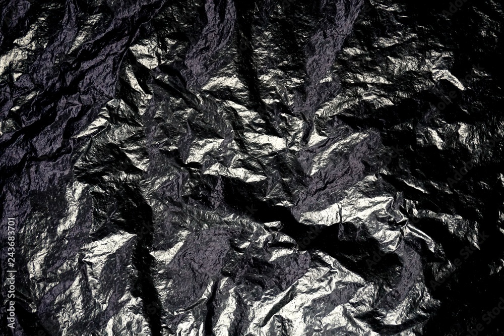 Glänzende schwarze Folie als Hintergrund Textur Stock Photo