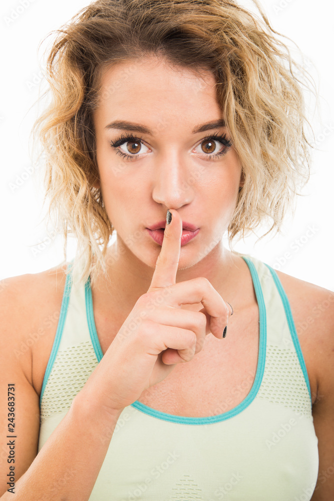 Portrait of fit girl making silence gesture Portrait of fit girl making silence gesture