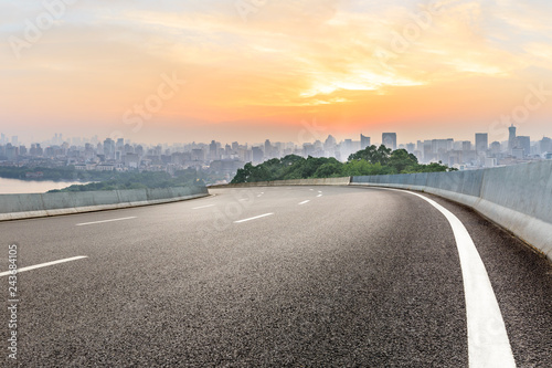 Panoramic city skyline and buildings with empty asphalt road at sunrise © ABCDstock