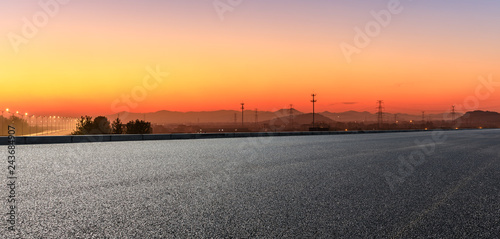Empty asphalt road and hills at beautiful sunset panoramic view