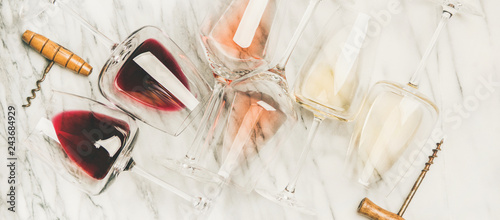 Red, rose, white wine in glasses and corkscrews, horizontal composition photo