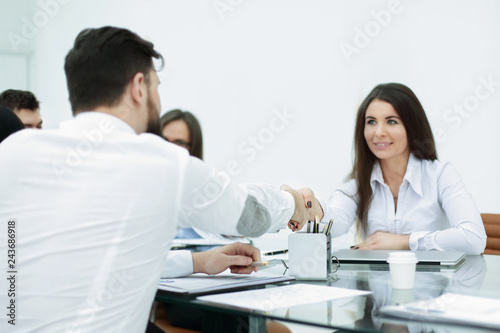 business woman is shaking hands with an employee at a work meeting © yurolaitsalbert