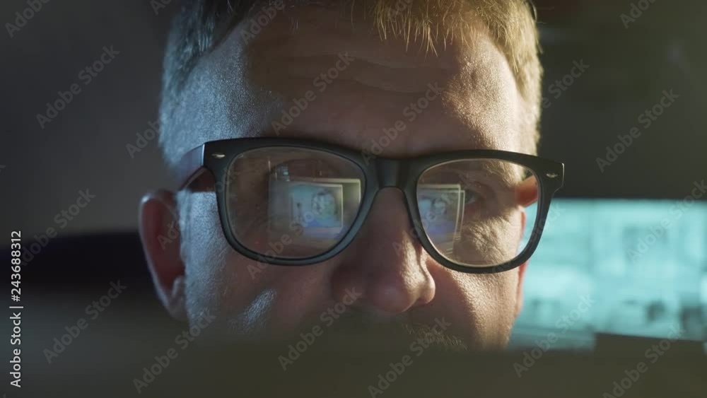 Man looks at screen with online lesson and smiles. Man looks at screen with online lesson and smiles.