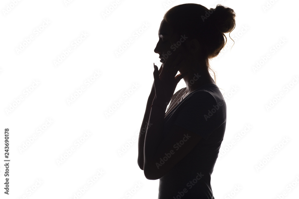 silhouette of a calm young woman on a white isolated background, figure of girl with hands on her face