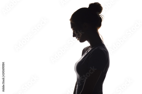 profile silhouette of a pensive girl, a young woman lowered her head down on a white isolated background
