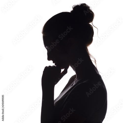 profile silhouette of a pensive girl with a hand at the chin, a young woman lowered her head down on a white isolated background