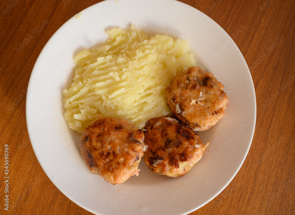 Home made cutlets with mashed potatoes on wooden table. Home made cutlets with mashed potatoes on wooden table.