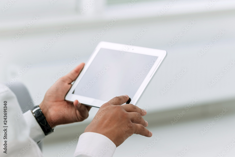 close up. businessman tapping the screen of the digital tablet