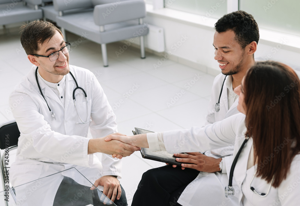 Fototapeta premium handshake of medical colleagues at the Desk in the hospital office