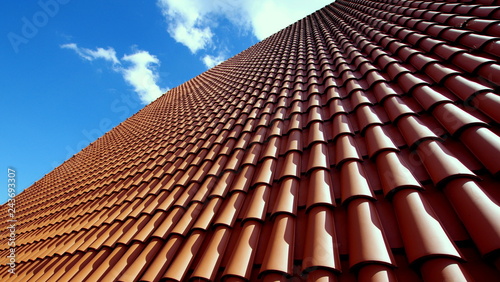 Sloping roof of the family house covered with red tiles